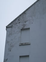 Severe penetrating damp issues caused by poor parapet wall detail