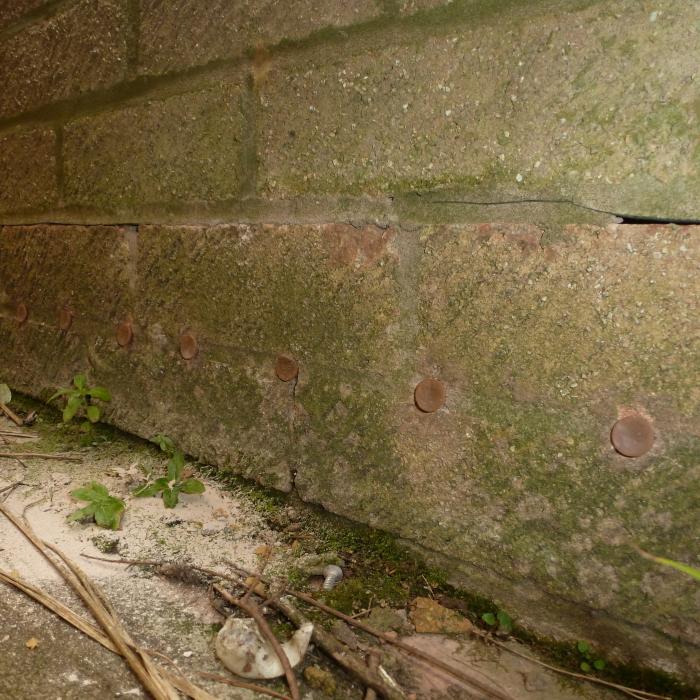 This is a classic. This contractor diagnosed this 1990's cavity built property with rising damp and decided to install a chemical damp proof course to the side elevation wall. Not only was the damp proof course installed approximately 75mm above external ground level but was installed into a modern building incorporating a horizontal physical Upvc damp proof course, which you can see within the mortar bed joint just above the chemical injection. Obviously the repair failed (through misdiagnosis) and when we were called to survey the property the causes was due to a toilet waste pipe leaking within the cavity. 