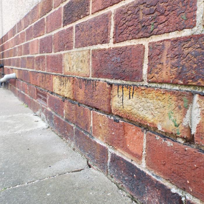 This is very unusual. A double damp proof course split over a single course of brick. These builder back in the 1950\'s were very conciencious. The purposes of this double installation was due to solid floors at the rear of the property and to alleviate a breach of teh first DPC by the floors, therfore a second dpc was installed above floor level. 