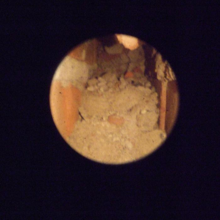 Borroscope view into a cavity wall revealing a blockage caused by mortar and debris build up most likely accumulated during the build bridging this damp proof course. 